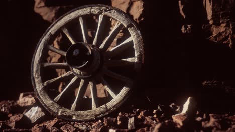 old-wooden-cart-wheel-on-stone-rocks